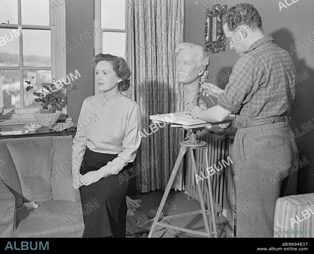 ' REFLECTED ' STAR . Posing for sculpture Baron WERNER VON ALVENSLEBEN in his London studio's is film actress PHYLLIS CALVERT . The head of Miss Calvert , to which Baron Von Alvensleben is putting the finishing touches is to be included in a forthcoming exhibition devoted to his sculptures of film and stage celebrities .. The Baron , 37 years of age , sculpts under the name ' Werner ' . 28 April 1949.