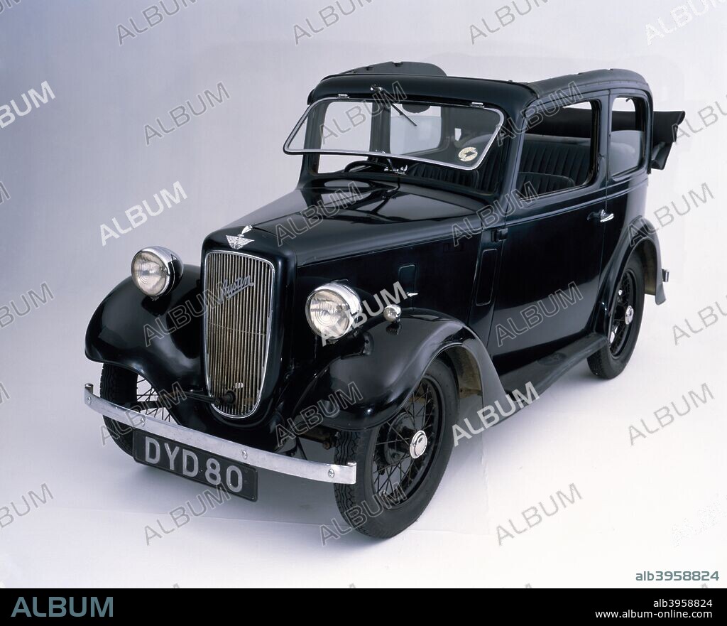1938 Austin 7 Pearl Cabriolet car. The Pearl Cabriolet was one of the last versions of the Austin Seven. By end of production in 1939, nearly 300,000 Sevens had been made. For 1932 the wheelbase and rear track were increased and for 1933 the three-speed gearbox was replaced by a four-speed. August 1934 saw dramatic changes, as the all-new Pearl and Ruby models were introduced, with dropped chassis frames and cowled radiators. The third jewel to appear in the Austin crown was the two-seater Opal, initially retaining the old style chassis and radiator. The Pearl Cabriolet featured fixed side windows with a rollback top. It was modified in early 1937, to remove crossbars between the cant rails so that the roof space could be completely open.