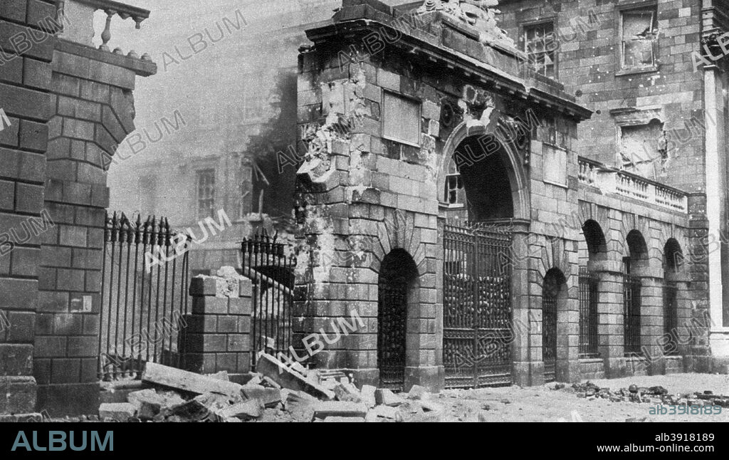 The Four Courts bombarded, Dublin, Ireland, July 1922 (1935). IRA members opposed to the terms of the Anglo-Irish Treaty of 1921 occupied the Four Courts in April 1922. In June, exasperated with the situation and under pressure from the British to resolve it, Michael Collins, leader of the Provisional Government of the Irish Free State, ordered the artillery bombardment of the Four Courts. A print from King Emperor's Jubilee, 1910-1935, by F G H Salusbury, Daily Express Publications, London, 1935.