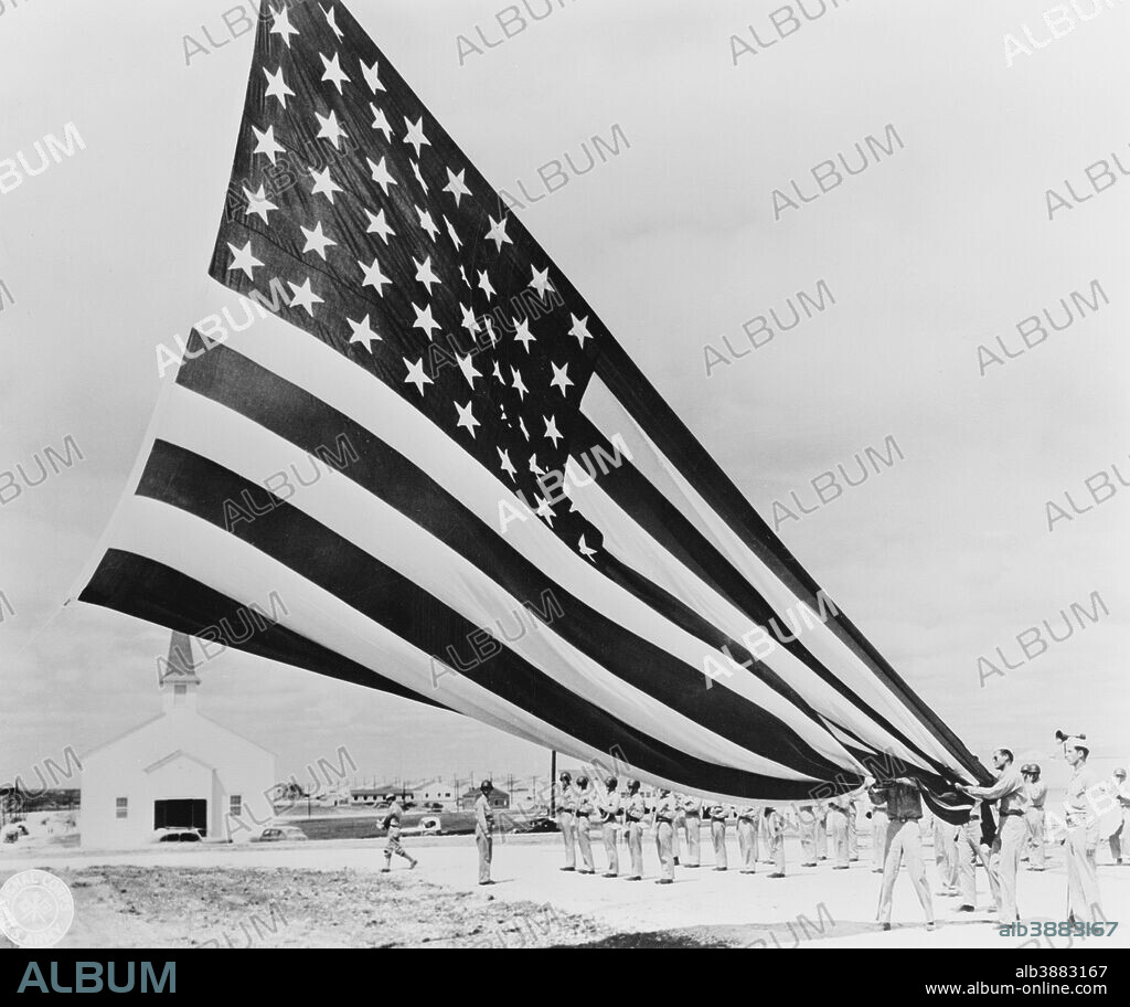 Soldiers unfolding Garrison flags at Fort Hood, Texas, circa 1935-1945.