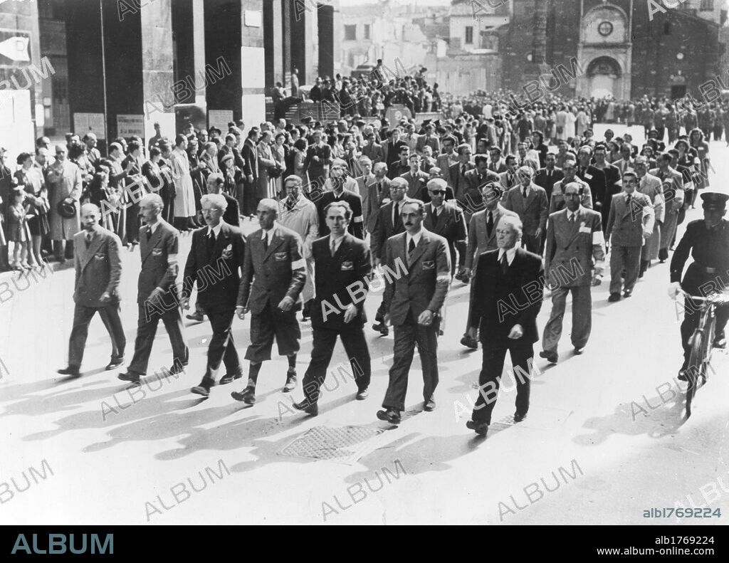 A CLNAI rally. The Italian anti-Fascist politicians Ferruccio Parri and Luigi Longo along with General Raffaele Cadorna Junior and entrepreneur Enrico Mattei taking part in a Committee of National Liberation of Upper Italy (CLNAI) rally. Milan, 6th May 1945.
