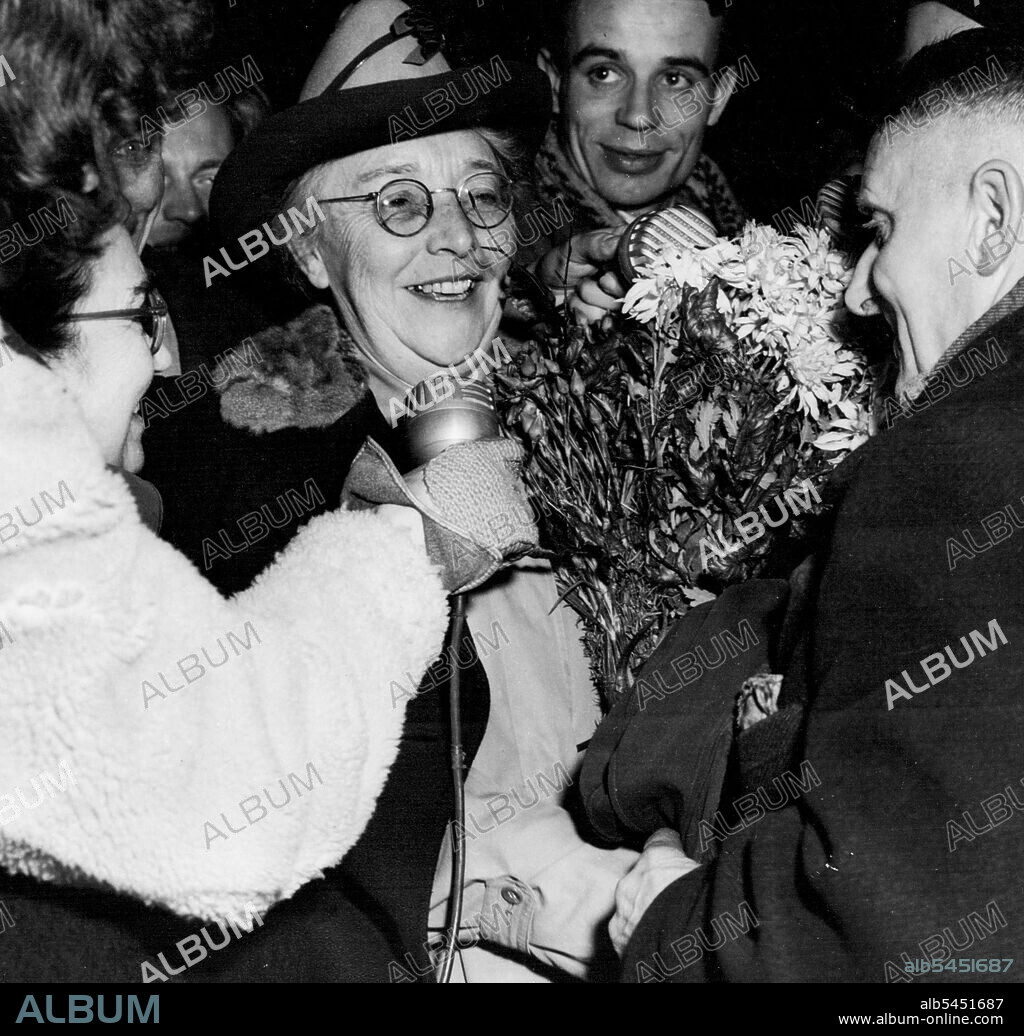 Berlin's Woman Mayor Back - Frau Louise Schroeder, the city's acting Mayor, surrounded by admiring Berliners as she spoke a few words lot Rias (American Licensed Radio Berlin) on her arrival at Templehof airfield, returning to the blockaded city after three months in Western Germany convalescing. She had been in poor health for the past year. November 25, 1948.