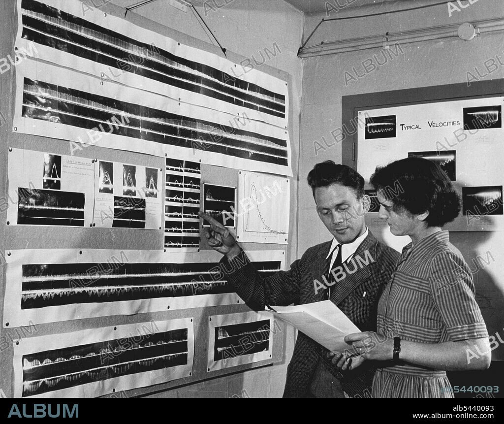 The largest Radio-Telescope In The World. Designed and constructed by members of Manchester University Physical laboratories at Jodrell Bank Experimental Station, in Cheshire. In the radio-telescope Receiving Hut the recordings of radio 'noise' received during the past 24 hours are checked daily and analysed. Results are compared to those received on previous days and radio noise made by passing motor cars or aeroplanes is eliminated, the remainder being charted as noise from the stars. (The sta.