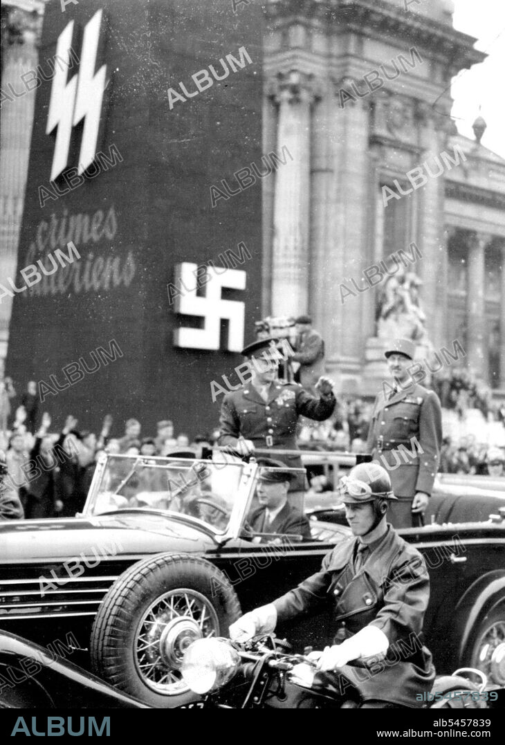 Paris Pays Tribute To IkeGeneral Eisenhower standing in an open car with General Koenig acknowledges the cheers of the crowd as they pass a reminder of Nazi occupation.At a ceremony at the Arc de Triomphe yesterday June 14, General De Gaulle decorated General Eisenhower with the companion of liberation. Parisians lined the streets of the capital giving the general a thunderous welcome. After pinning the decoration on Ike's Tunic Gen. De Gaulle kissed the allied leader on both cheeks after the ceremony General Eisenhower drove down the Champs Elysees acknowledging the cheers of the crowd. July 2, 1945.
