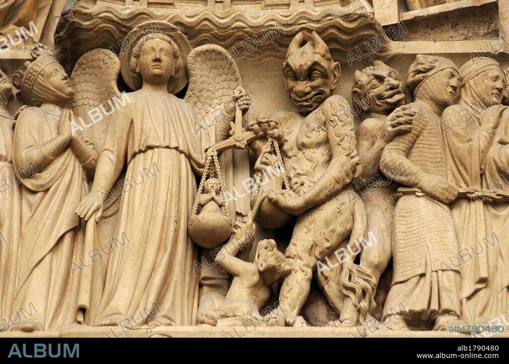 Gothic Art. France. Paris. Notre Dame. Sculptures decorating the portal of the Last Judgment. It was built in the 1220s-1230s. Facade. The archangel Michael is weighing their souls with a furry Devil's interference. Paris.