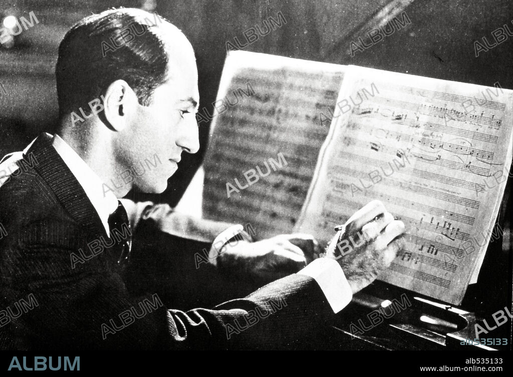 George Geshwin composing at the piano, 1936.