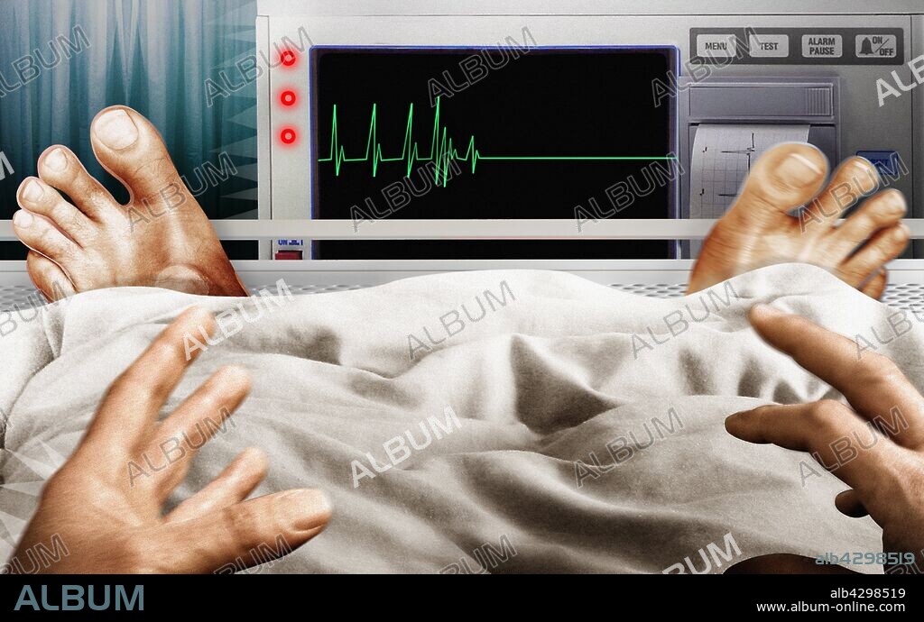 Frightened man in hospital bed seeing flatline pulse trace on monitor.