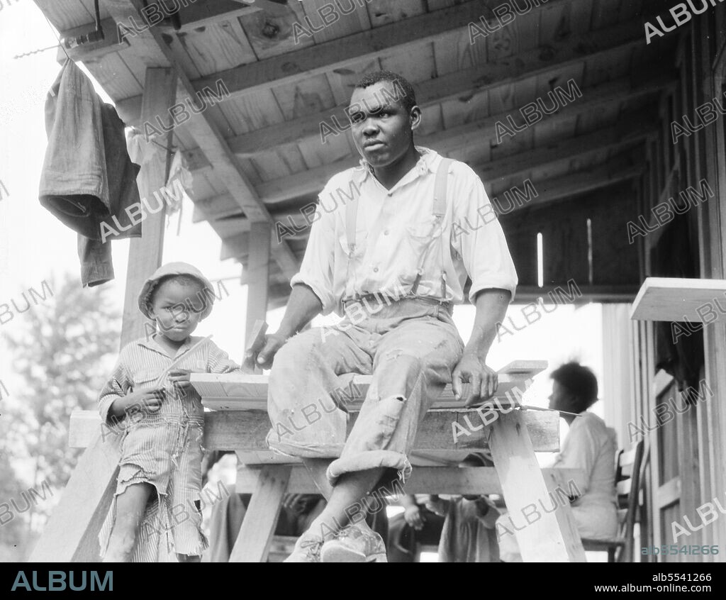 DOROTHEA LANGE. Evicted Arkansas sharecropper. One of the more active of the union members (Southern Tenant Farmers Union). Now building his new home at Hill House, Mississippi.
