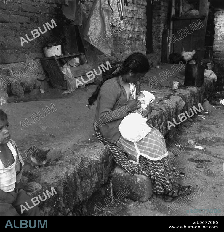 Ethnology / America:. Guatemala. Woman breast-feeding an infant. Photo, undated.
