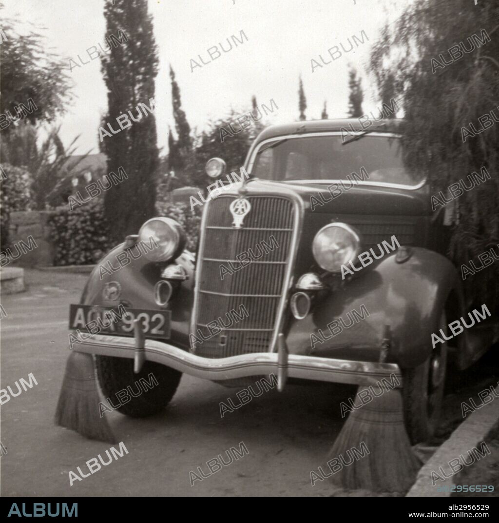 Photograph of a motor car with brooms to sweep away tracks thrown by strikers during the Palestine riots. Dated 1936.