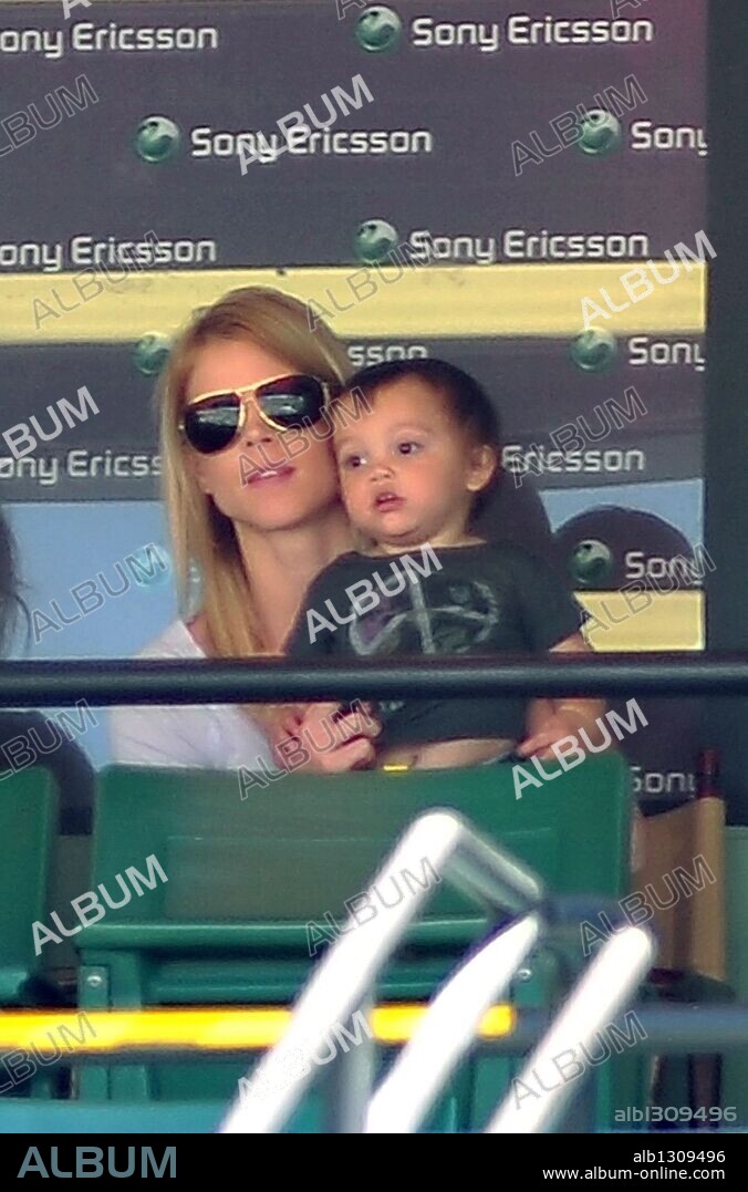 Apr 02, 2010 - Key Biscayne, Florida, USA - Tigers wife ELIN NORDEGREN holds her son CHARLIE WOODS as she sits to watch the action during a men's semifinal match at the Sony Ericsson Open at the Crandon Park Tennis Center in Key Biscayne. On December 11, 2009, Woods announced he would take an indefinite leave from professional golf to focus on his marriage after he admitted infidelity. 02/04/2010