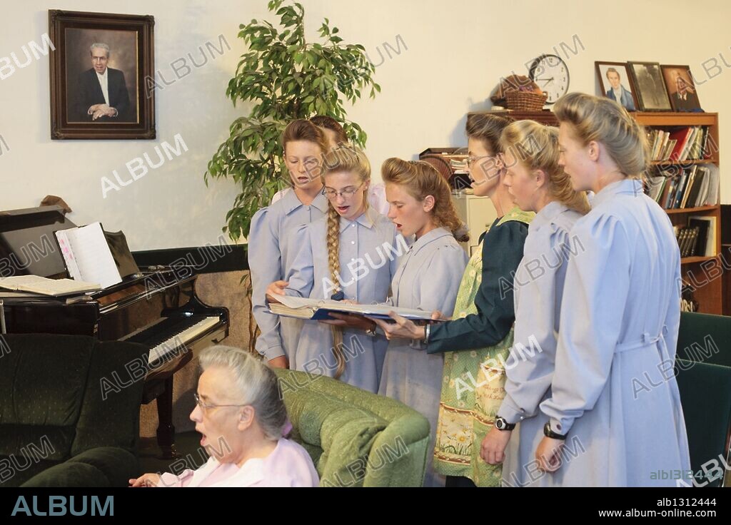Aug 10, 2008 - Colorado City, Arizona, USA - Members of the Jessop family sing and play instruments in the living room of their home in Colorado City, AZ. The family has computers and cell phones but have chosen not to have televisions, instead they put on impromptu concerts nightly. They have more than 40 instruments in the house. The Jessops are polygamists and members of the FLDS. Colorado City and neighboring town of Hildale, UT, are home to the Fundamentalist Church of Jesus Christ of Latter Day Saints (FLDS) which split from the mainstream Church of Jesus Christ of Latter Day Saints (Mormons) after the Mormons banned plural marriage (polygamy) in 1890 so that Utah could gain statehood into the United States. The FLDS Prophet (leader), Warren Jeffs, has been convicted in Utah of "rape as an accomplice" for arranging the marriage of teenage girl to her cousin and is currently on trial for similar, those less serious, charges in Arizona. After Texas child protection authorities raided the Yearning for Zion Ranch, (the FLDS compound in Eldorado, TX) many members of the FLDS community in Colorado City/Hildale fear either Arizona or Utah authorities could raid their homes in the same way. Older members of the community still remember the Short Creek Raid of 1953 when Arizona authorities using National Guard troops, raided the community, arresting the men and placing women and children in "protective" custody. After two years in foster care, the women and children returned to their homes. After the raid, the FLDS Church eliminated any connection to the "Short Creek raid" by renaming their town Colorado City in Arizona and Hildale in Utah. (Credit Image: © Jack Kurtz/ZUMA Press) RESTRICTIONS: * Tabloids Rights OUT * Note to editors: subjects not to be portrayed in a negative way *. 10/08/2008