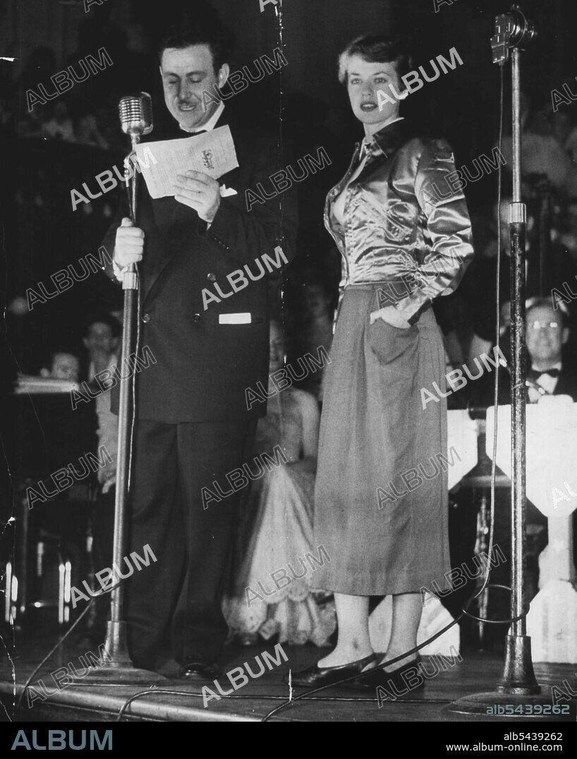 Disc Jockey Bill McColl from Station 2KY, arranged and compered bodgey-widge get-together at Sydney Town Hall with him is Jan Lane (18) from Marrickville, who was asked to display latest Widgie fashions on stage. In 1951 he staged and compered a bodgie-Widgie get-together at Sydney Town Hall. Jan Lane (18), from Marrickville, was asked to step on to stage and show latest Widgie fashions. January 12, 1955.;Disc Jockey Bill McColl from Station 2KY, arranged and compered bodgey-widge get-together a.