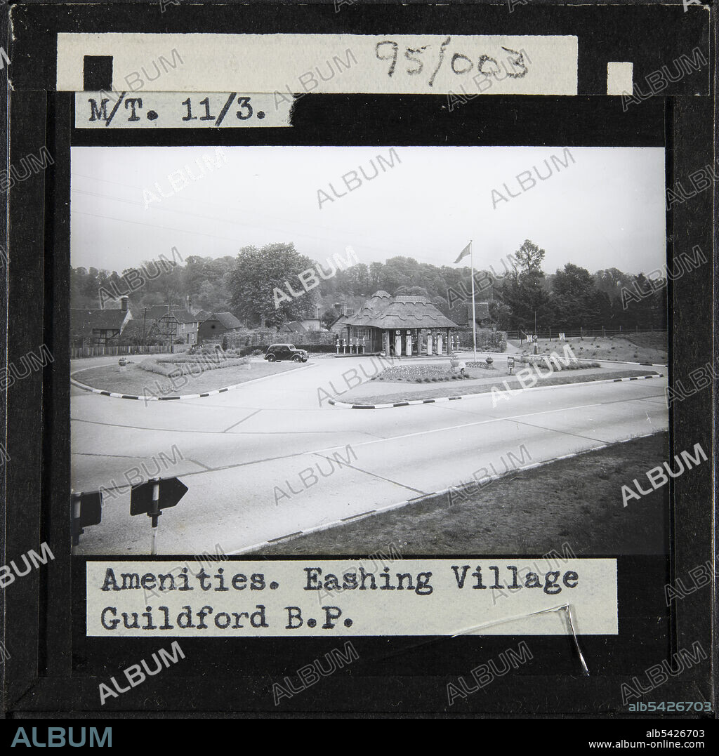 Eashing Petrol Station, Lower Eashing, Shackleford, Guildford, Surrey, 1930s. A car parked outside the thatched BP petrol station on the Guildford and Godalming Bypass at Lower Eashing. The caption on this slide reads: "Amenities. Eashing Village Guildford B.P.".