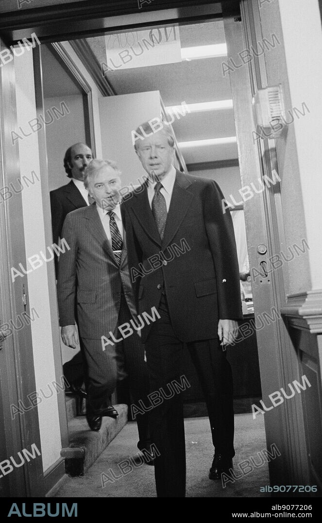 President Jimmy Carter walking with members of the Three Mile Island Commission. The Three Mile Island nuclear reactor had a partial meltdown, one of the worst accident in U.S. Commercial nuclear power plant history. By Marion S. Trikosko. Dated 1979.