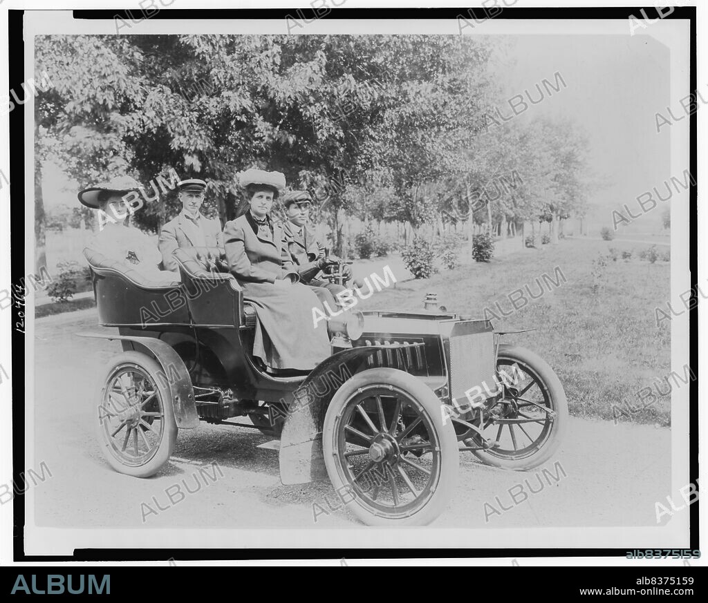 Frances Benjamin Johnston seated with three other people in automobile, between 1890 and 1910.