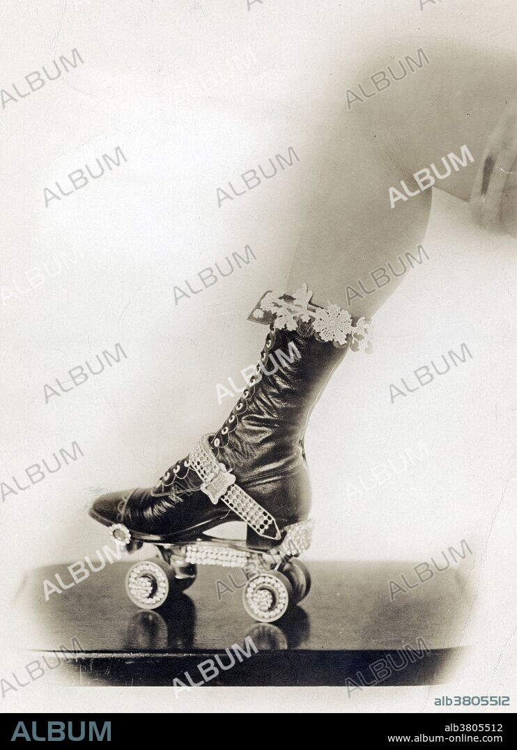 Entitled: "Jewels" shows a portion of a woman's leg and foot wearing a shoe strapped into a bejeweled roller skate. The four-wheeled turning roller skate, or quad skate, with four wheels set in two side-by-side pairs( front and rear ), was first designed by James Leonard Plimpton. The skate contained a pivoting action using a rubber cushion that allowed the skater to skate a curve just by pressing his weight to one side or the other, most commonly by leaning to one side. The design of the quad skate allowed easier turns and maneuverability, and the quad skate came to dominate the industry for more than a century. Roller skating is a recreational activity, a sport, and a form of transportation. Photographed by Jessie D. Allardice, October 5, 1920.