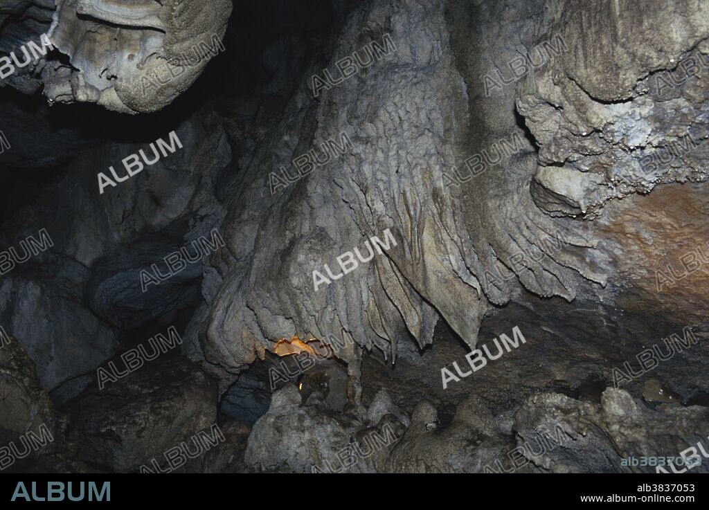 Drapery or shawl formations (also called cave ghosts) occur in Oregon Caves National Monument when calcite-rich water loses its carbon dioxide to the cave's atmosphere and forms sheets.