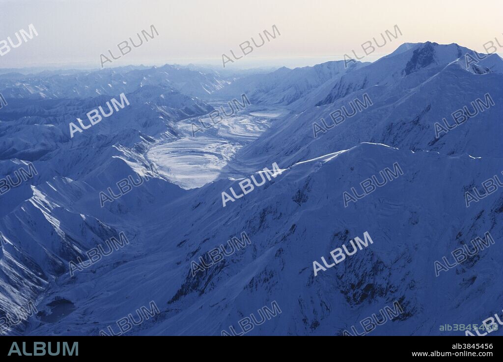 Glacier in the Alaska Range, Alaska.  Bending curves and patterns identify the fact that these "rivers of ice" flow.