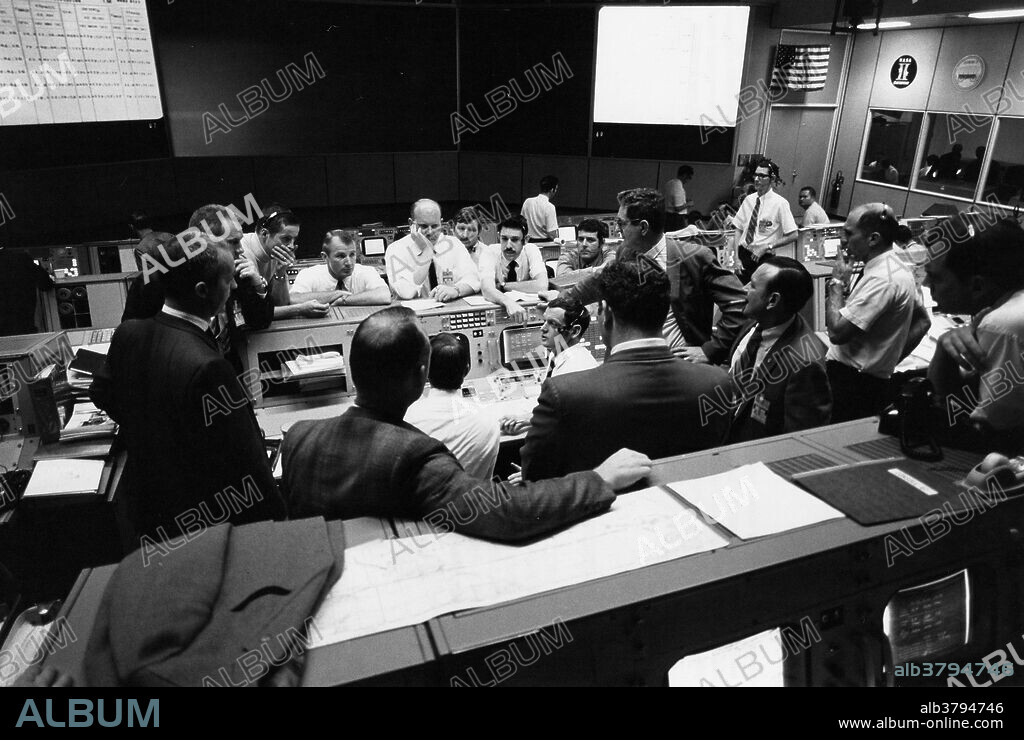 Overall view showing some of the activity in the Mission Operations Control Room (MOCR) of the Mission Control Center (MCC) during the final 24 hours of the Apollo 13 mission. Here, flight controllers and several NASA/MSC Officials confer at the flight director's console. When this picture was made, the Apollo 13 moon landing had been cancelled and the Apollo 13 crewmen were in transearth trajectory attempting to bring their crippled spacecraft back home (35368); Discussion in the MOCR dealing with the Apollo 13 crewmen during their final day in space. From left to right are Glynn S. Lunney, Shift 4 Flight Director; Gerald D. Griffin, SHift 2 Flight Director; Astronaut James A. McDivitt, Manager, APollo Spacecraft Program, MSC; Dr. Donald K. Slayton, Director of Flight Crew Operations, MSC; and Dr. Willard R. Hawkins, M.D., Shift 1 Flight Surgeon (35369).