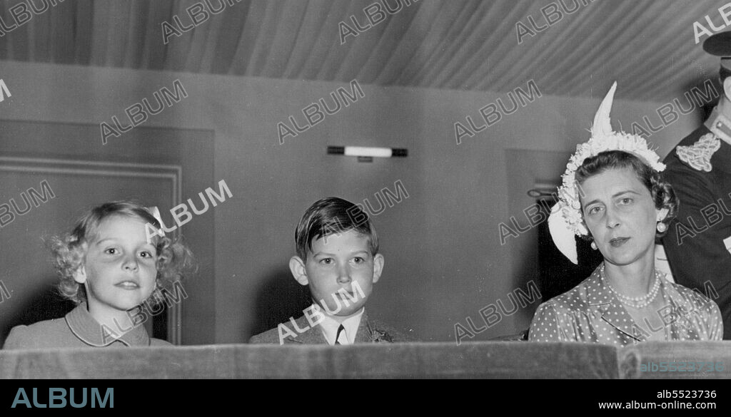 The Duchess At Royal Tournament -- Duchess of Kent, wearing an attractive feathred cloche, with her son, Prince Michael of Kent, and a friend, when they attended a performance of the Royal tournament at Earl's Court here. June 21, 1950.