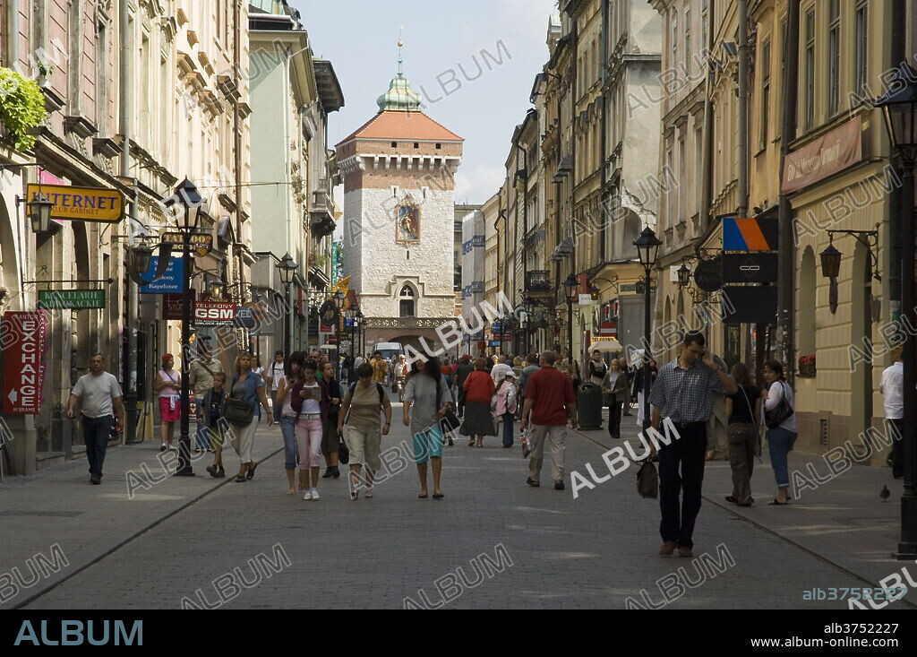 Looking down Florianska street towards the Barbican and Florian's Gate on the old city walls, UNESCO World Heritage Site, Krakow (Cracow), Poland, Europe.