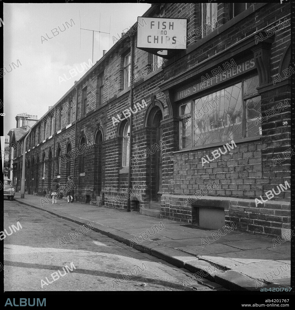 Titus Street, Saltaire, Shipley, Bradford, West Yorkshire, c1966-c1974. A view looking east along Titus Street showing houses on the south side of the street with the Titus Street Fisheries at 39 Titus Street in the foreground.