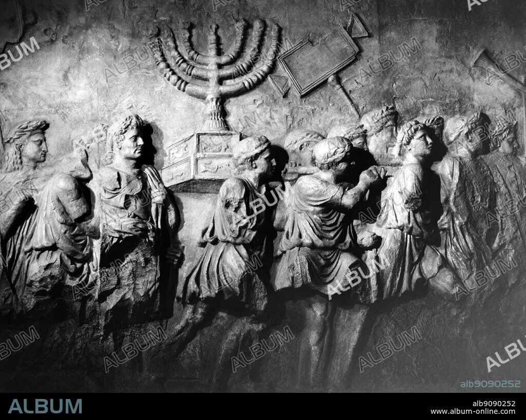 Relief from the Arch of Titus, Rome, showing the trophies from the sack of the Temple of Jerusalem - partly restored.. The Arch of Titus is a Pentelic marble triumphal arch with a single arched opening, located on the Via Sacra just to the south-east of the Forum in Rome. It was constructed by the emperor Domitian shortly after the death of his brother Titus (born AD 41, emperor 79-81), commemorating the capture and sack of Jerusalem in 70, which effectively terminated the Jewish War begun in 66 (although the Romans did not achieve complete victory until the fall of Masada in 73).. ©TopFoto.