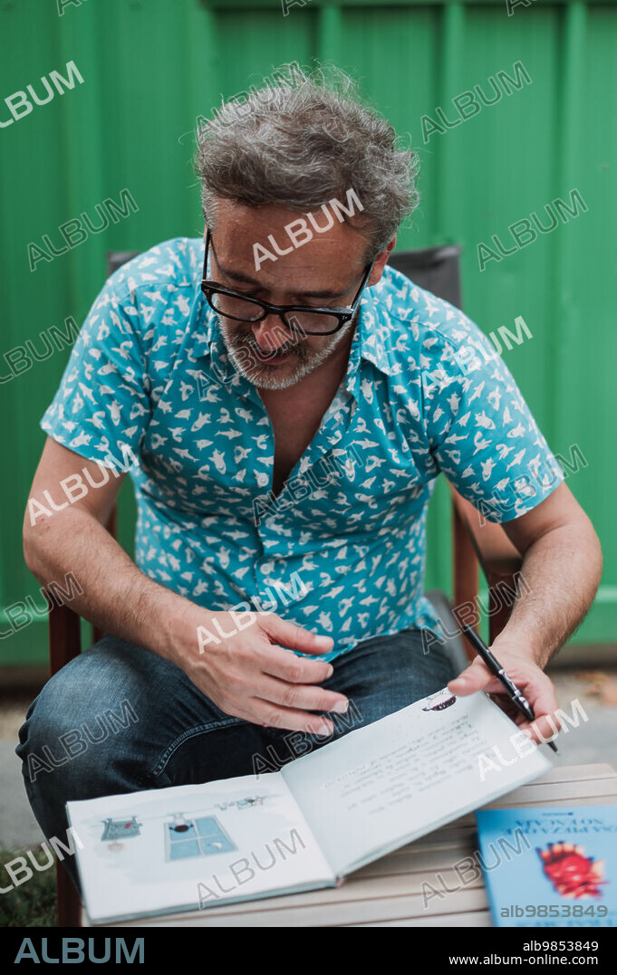 Santi Balmes, Spanish indie-pop musician and writer, front man of the band Love of Lesbian, signing his books in Zaragoza, Spain .