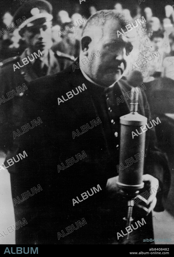 Tiso Gives The Soft Answer - Study in injured innocence provided by Dr. Josef Tiso, priest who founded the puppet State of Slovakia under Hitler's protection, as he answered questions put to him by members of the High Court at Bratislava.In clerical dress and with fingers together in priestly manner, Tiso, soon to be tried himself, was giving evidence during the trial of other collaborationists. August 29, 1946.
