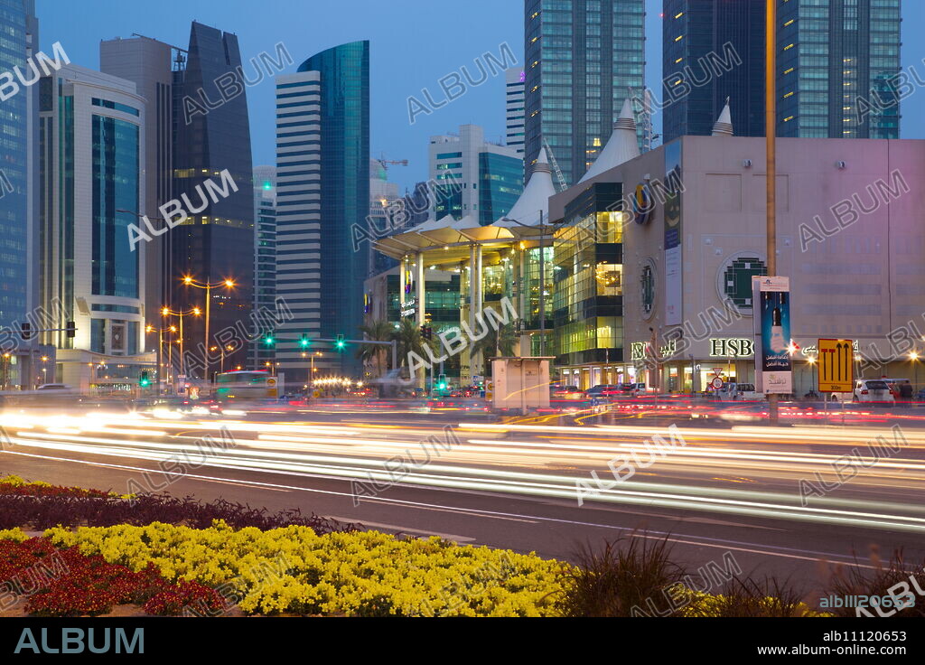 Contemporary architecture and traffic at dusk in the city centre, Doha, Qatar, Middle East.