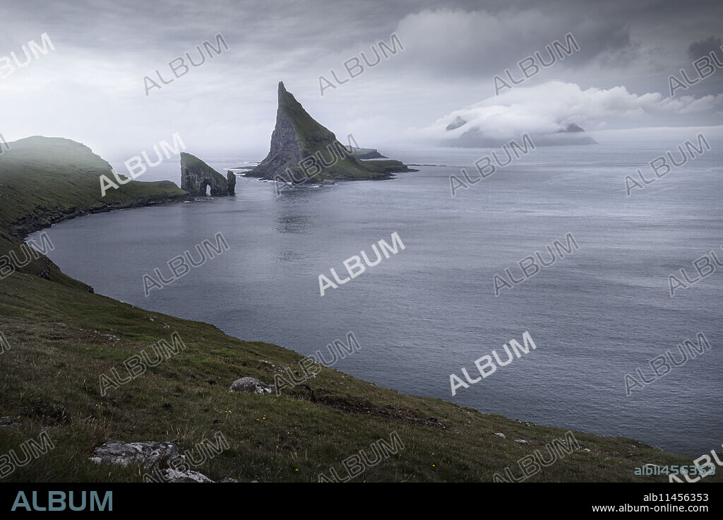 View over the bay with Drangarnir and Tindholmur, Faroe Islands, Denmark, Europe.