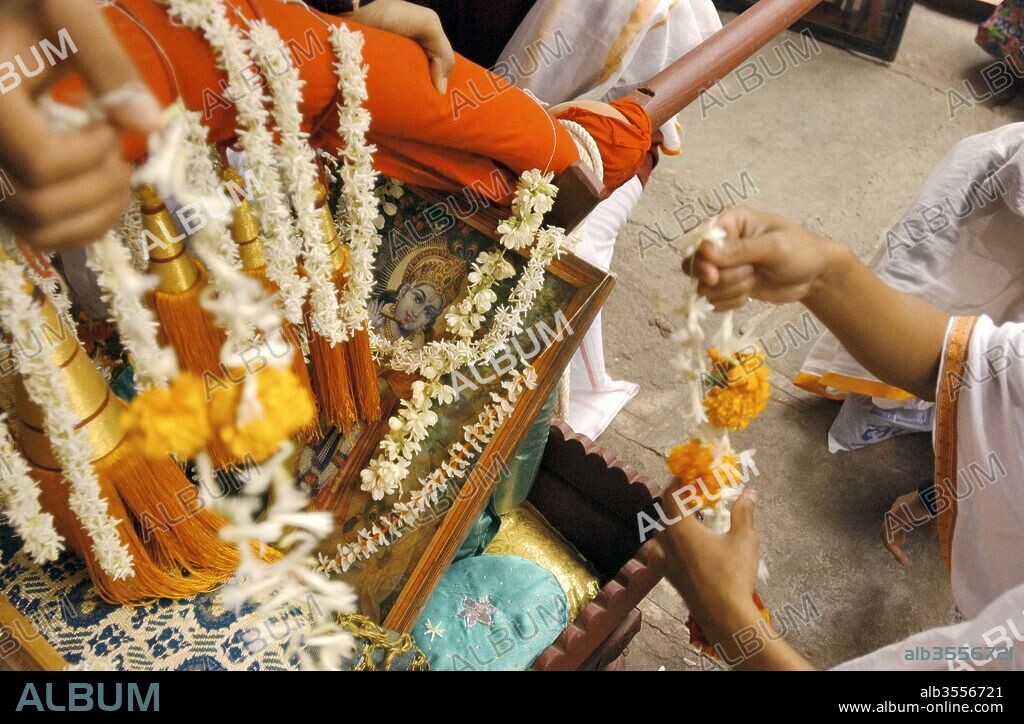 Devotees decorate Krishna 'palkhi' before the procession ;  Poona ;  Maharastra ;  India.
