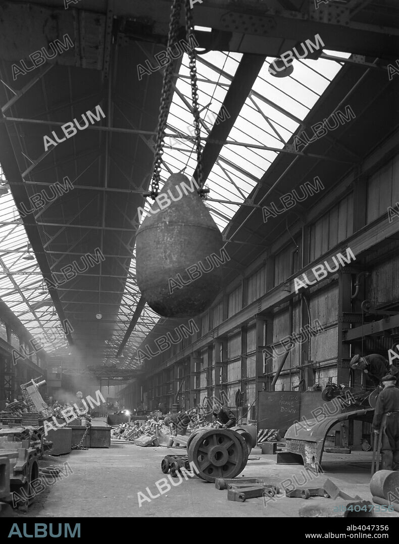 Edgar Allen steel foundry, Meadowhall, Sheffield, South Yorkshire, 1962. Work is being carried out on a dragline bucket on the right of the photograph whilst a giant counterweight hangs above.