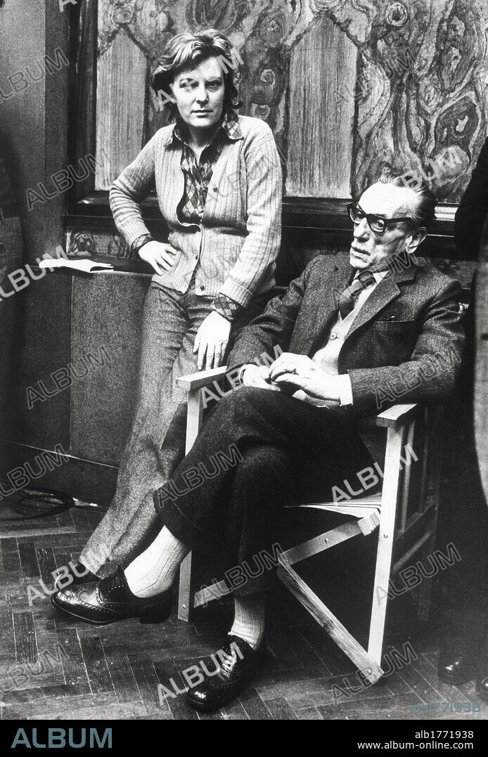 Liliana Cavani with Eduardo De Filippo on the set of 'The Night Porter' ('Il Portiere di Notte'). The Italian director and screenplayer Liliana Cavani is photographed on the set of her film 'The Night Porter' ('Il Portiere di Notte') with the actor and director Eduardo De Filippo, visiting her as a guest of her crew. Rome, 1973.