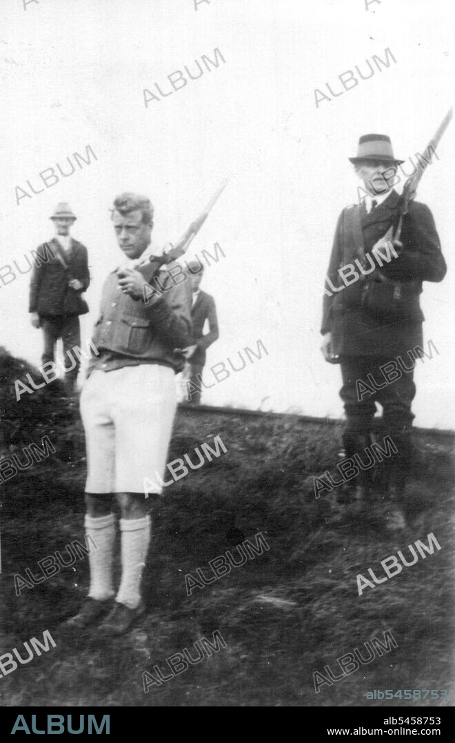 The King Shoots In Styrian Costume. The King wore Styrian hinting costume when he went partridge shooting in the old royal estate at Luxemburg, 15 miles from Vienna. O.P.S. The King in loather shorts, a green jacket with silver buttons and white socks, on the hunting ground which had been placed at his disposal by the Austrian Government. October 05, 1936.