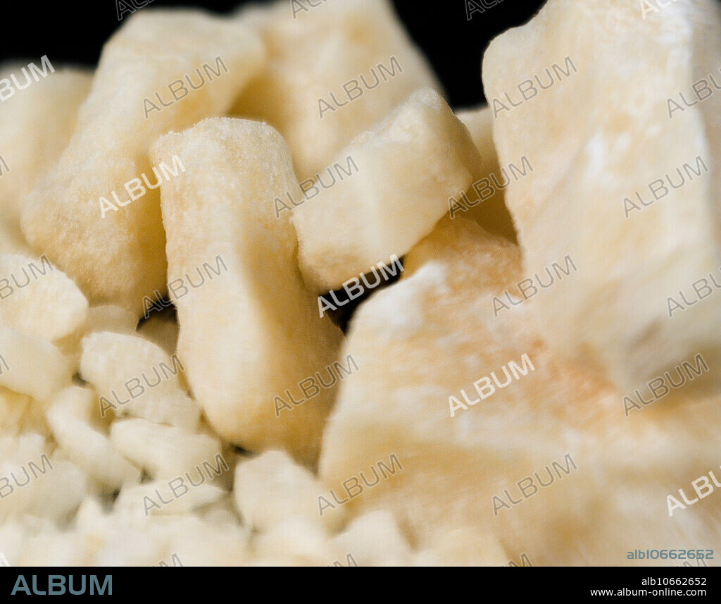 Crack cocaine rocks. Crack cocaine is a highly addictive and powerful stimulant that is derived from powdered cocaine using a simple conversion process. Crack emerged as a drug of abuse in the mid-1980s. It produces an immediate high and is easy and inexpensive to produce rendering it readily available and affordable. Crack is produced by dissolving powdered cocaine in a mixture of water and ammonia or sodium bicarbonate (baking soda). The mixture is boiled until a solid substance forms. The solid is removed from the liquid, dried, and then broken into the chunks (rocks) that are sold as crack cocaine. The name crack refers to the sound generated during its manufacture and when smoked. Street names include: rock, hard, iron, cavvy, base, or just.