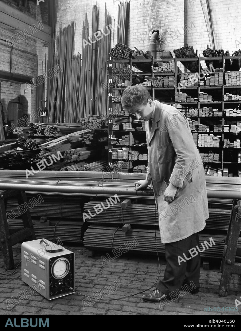 Ultrasonic testing of steel, J Beardshaw & Sons, Sheffield, South Yorkshire, 1963. In part of the warehouse storing flat steel bars, a technician from tests the metal with an ultrascope made by the Ultrascope Company (London) Ltd. An ultrascope passes sound waves through the metal and this detects any flaws within it.