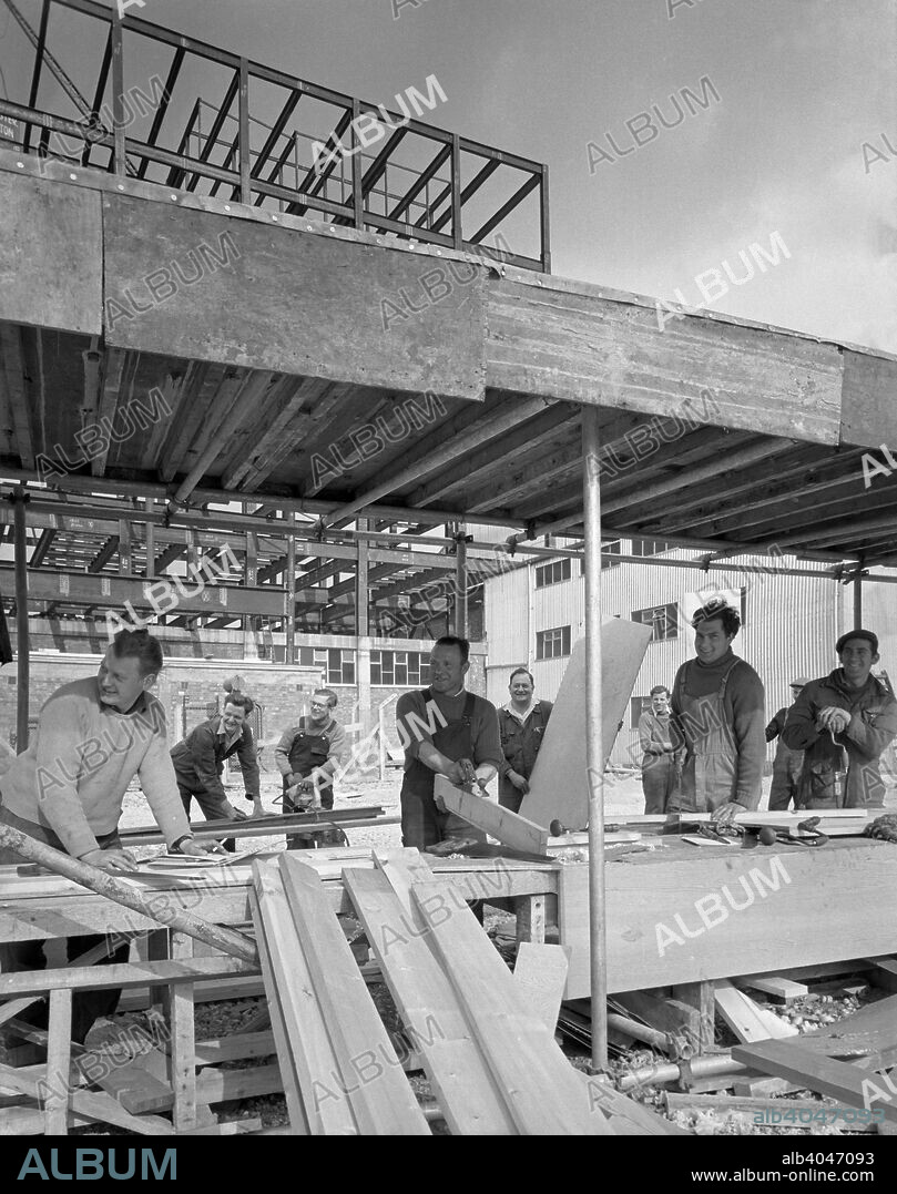 Carpenters on a building site, Gainsborough, Lincolnshire, 1960. This PR photograph for construction company George Wimpey & Co shows carpenters working on the site of the new warehouse they were constructing for Spillers Foods in Gainsborough.