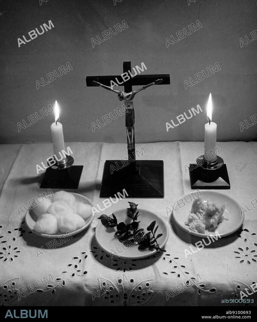 Anointing of the sick. The sickroom prepared with crucifix, 2 candles some holy water a sprig of shrub six pieces of cotton wool for wiping the oil, and some bread for cleansing the priests fingers.