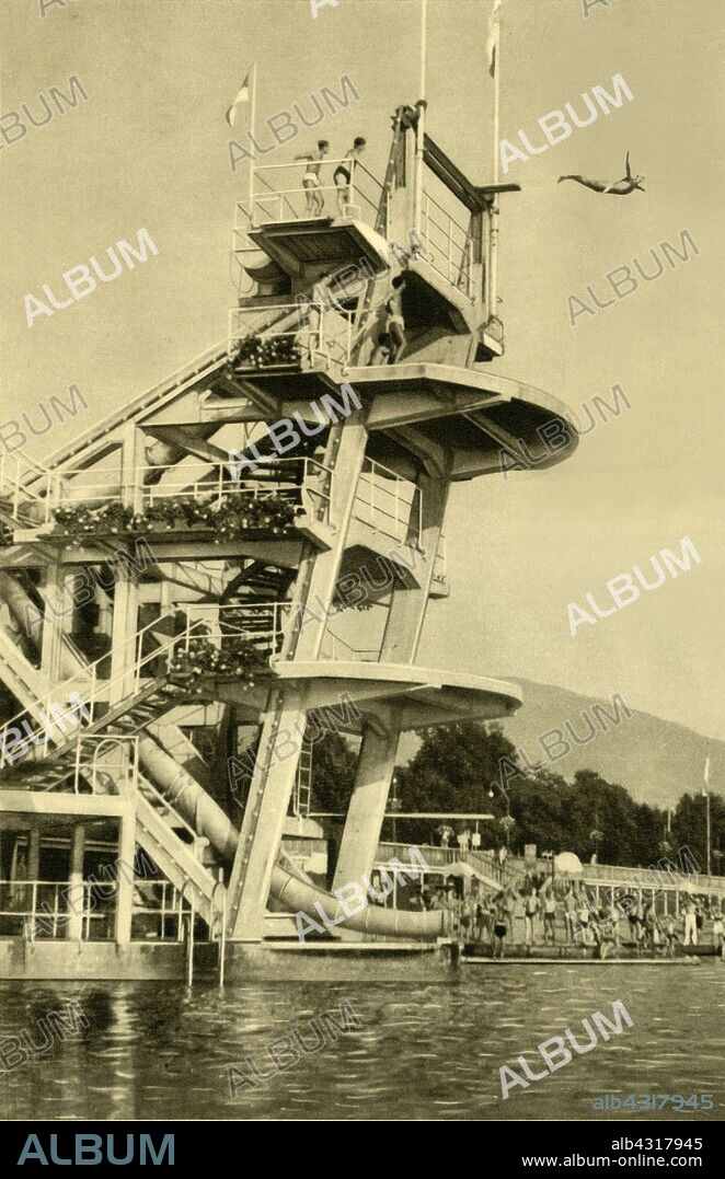 Diving platform, Millstatt, Carinthia, Austria, c1935. Holidaymakers at the health resort and spa town of Millstatt on the Millstätter See (Lake Millstatt), in the state of Carinthia. From "Österreich - Land Und Volk", (Austria, Land and People). [R. Lechner (Wilhelm Müller), Vienna, c1935].