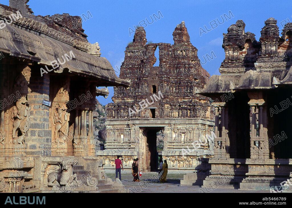 The Vittala Temple, built in the early 16th century, is devoted to the Hindu god Vithoba (also known as Vitthala and Panduranga), an incarnation of Vishnu or his avatar Krishna. Hampi is a village in northern Karnataka state. It is located within the ruins of Vijayanagara, the former capital of the Vijayanagara Empire. Predating the city of Vijayanagara, it continues to be an important religious centre, housing the Virupaksha Temple, as well as several other monuments belonging to the old city.