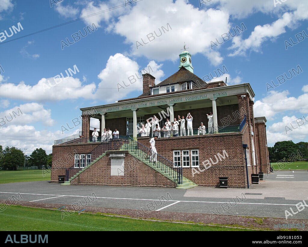 SIMON INGLIS. City of London School Sports Ground, Pavilion, Grove Park, Bromley, Greater London Authority, 2011. Cricket players celebrating outside the west elevation of the pavilion in the City of London School Sports Ground, Grove Park. The pavilion was designed by Ralph Knott and E S Collins. It was opened in 1925 and is dedicated to those of died in the First World War.