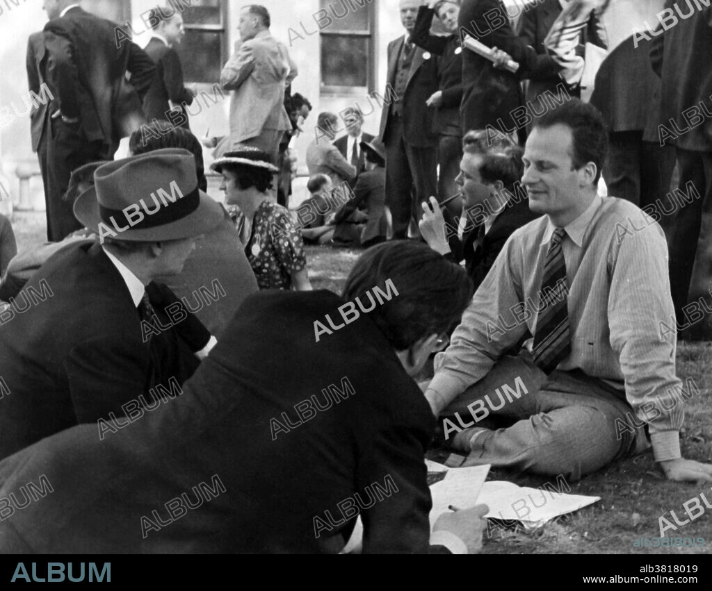 Hans Albrecht Bethe (1906-2005) being interviewed by journalists. Bethe, German-American nuclear physicist, won the Nobel Prize in Physics for his work on the theory of stellar nucleosynthesis. He also made important contributions to quantum electrodynamics, nuclear physics, solid-state physics and astrophysics. During World War II, he was head of the Theoretical Division at the Los Alamos laboratory, where he played a key role in calculating the critical mass of atomic bombs, and did theoretical work on the implosion method used in both the Trinity test and the "Fat Man" weapon dropped on Nagasaki, Japan. Bethe also played an important role in the development of the larger hydrogen bomb. He later campaigned with Albert Einstein in the Emergency Committee of Atomic Scientists against nuclear testing and the nuclear arms race. He influenced the White House to sign the ban of atmospheric nuclear tests in 1963 and the 1972 Anti-Ballistic Missile Treaty, SALT I.