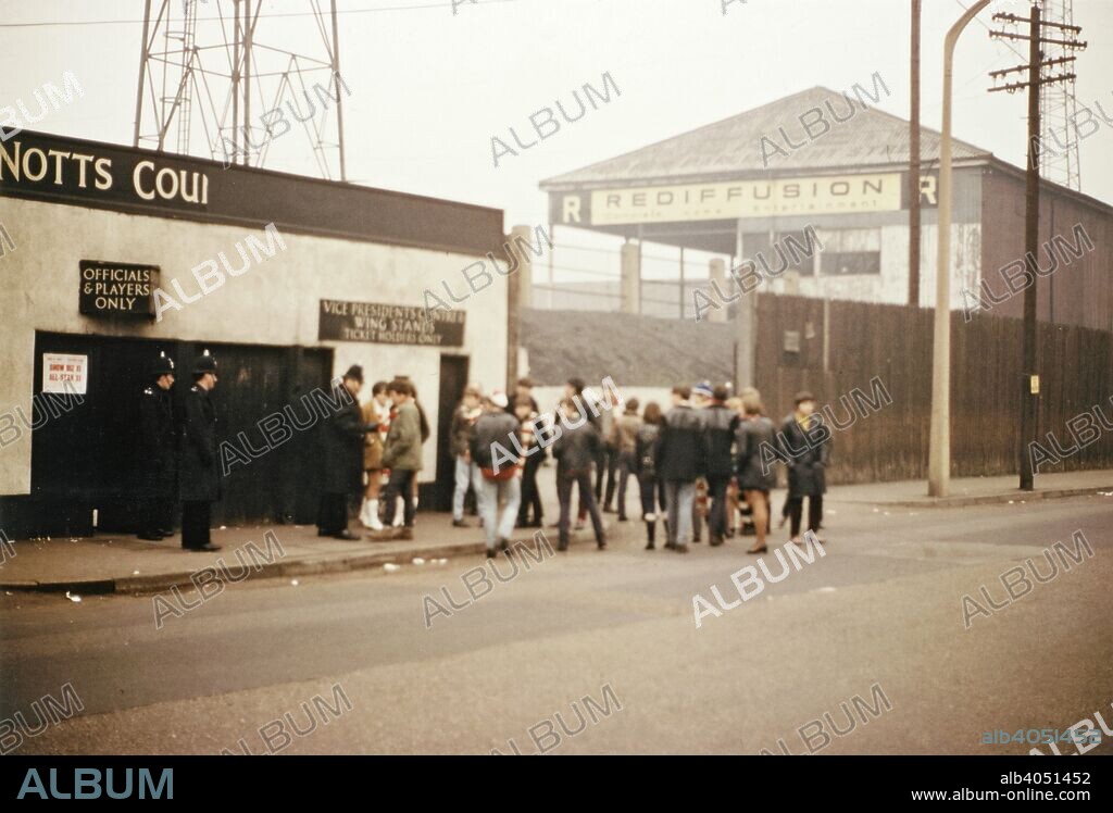 Outside the Notts County football ground, Meadow Lane, Nottingham, Nottinghamshire, 1968. This view shows the Meadow Lane entrance to the ground. Notts County was formed in 1862 and was a founder member of the English Football League in 1888. The Meadow Lane stadium, the club's home since 1910, was completely rebuilt in the 1990s at a cost of £8 million and has a capacity of 20,300, all seated.