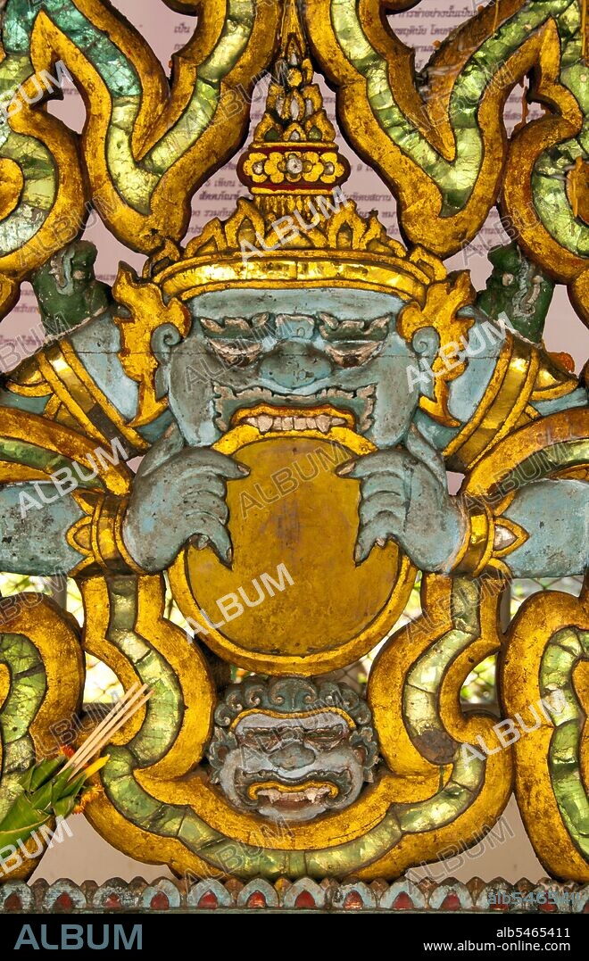 In Hindu mythology, Rahu is a snake that swallows the sun or the moon causing eclipses. He is depicted in art as a dragon with no body riding a chariot drawn by eight black horses. Rahu is one of the navagrahas (nine planets) in Vedic astrology. The Rahu kala (time of day under the influence of Rahu) is considered inauspicious. According to legend, during the Samudra manthan, the asura Rahu drank some of the divine nectar. But before the nectar could pass his throat, Mohini (the female avatar of Vishnu) cut off his head. The head, however, remained immortal. It is believed that this immortal head occasionally swallows the sun or the moon, causing eclipses. Then, the sun or moon passes through the opening at the neck, ending the eclipse. Wat Pong Sanuk Tai or 'The Monastery of the Southern Fun Marsh' was built in the late 18th century combining Burmese and Lanna styles of architecture. The temple's mondop is one of the finest examples of its type and is a marvelous blend of Lanna and Burmese workmanship. Lampang was originally founded during the 7th century Dvaravati period. Nothing remains from these early times, but the city is rich in temples, many of which have a distinctly Burmese flavour as Lampang had a substantial Burmese population in the 19th century, most of whom were involved in the logging industry.