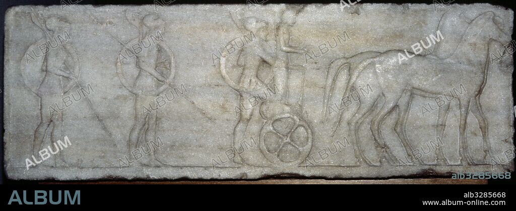 Base de un kuros arcaico con escena de soldados hoplitas y una cuádriga. Realizado en mármol con restos de policromía, data del año 510-500 a. C. Fue utilizado en el 478 a. C. como material de relleno del muro de Thémistocles. Museo Arqueológico Nacional. Atenas. Grecia.