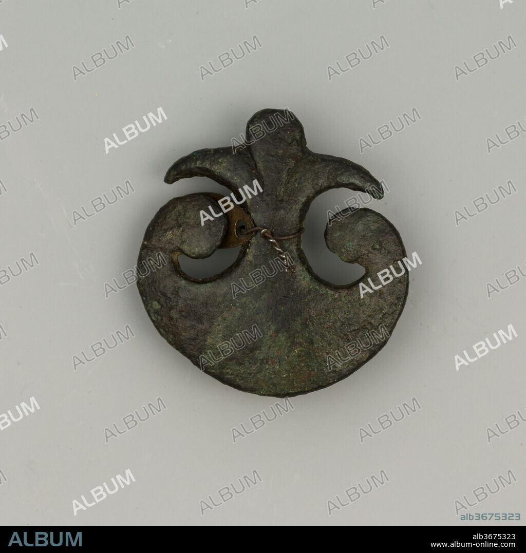 Horse Tack Ornament. Culture: Roman-German. Dimensions: Diam. 1 3/8 in. (3.5 cm); Wt. 0.6 oz. (17 g). Date: 2nd-3rd century.
This small bronze element, shaped as a <i>pelta</i> shield, decorated the horse tack of a German-Roman rider, probably fighting in the Imperial army.
The <i>pelta</i> was the traditional Thracian light infantry shield during Hellenistic times, and the shield of the legendary Amazons. During the Roman period it was used as an apotropaic ornament (a protection from the evil eye) and possibly a symbol of the warrior's virtues.