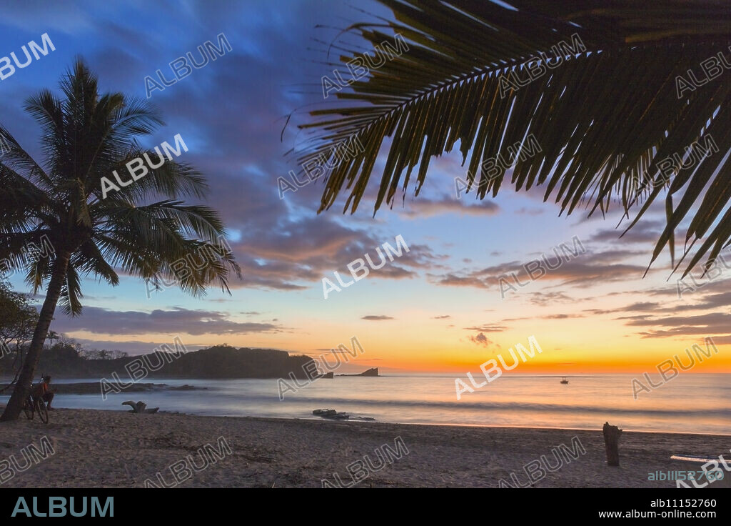 Sunset by the southern headland of beautiful Playa Pelada beach, Nosara, Nicoya Peninsula, Guanacaste Province, Costa Rica.