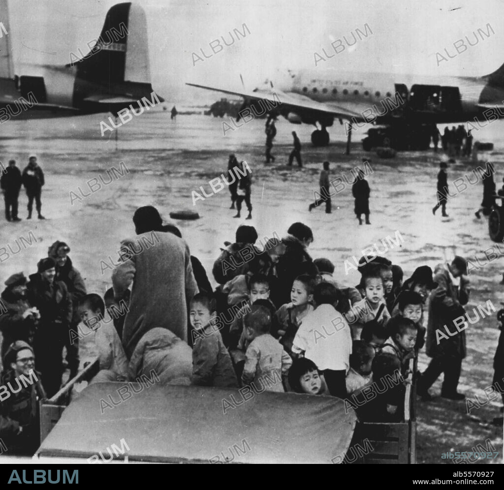 Mercy Airlift For Waifs -- A truckload of Korean children arrives at Kimpo Air Base in Seoul for evacuation to an island haven off South Korea during United Nations airlift of over 1,000 orphans from the northwest battlefront area. some of the 15 C-54 planes of the U.S Far East Air Force's Combat Cargo Command await their pathetic cargo in back round. February 10, 1951. (Photo by AP Wirephoto).